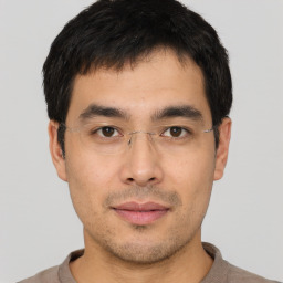 Joyful asian young-adult male with short  black hair and brown eyes