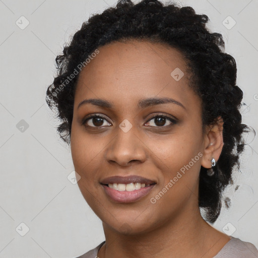 Joyful black young-adult female with long  black hair and brown eyes