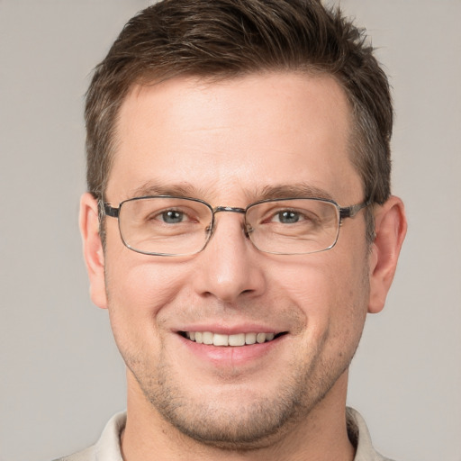 Joyful white adult male with short  brown hair and grey eyes