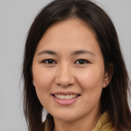 Joyful asian young-adult female with long  brown hair and brown eyes