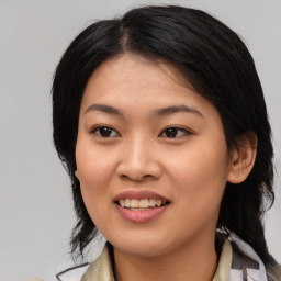 Joyful asian young-adult female with medium  black hair and brown eyes