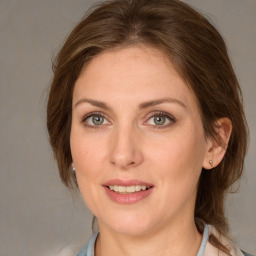 Joyful white young-adult female with medium  brown hair and blue eyes