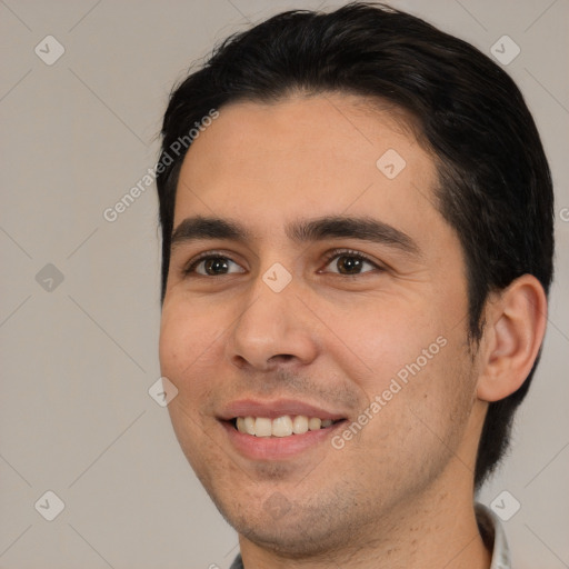 Joyful white young-adult male with short  black hair and brown eyes