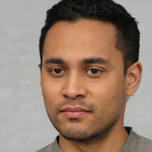 Neutral latino young-adult male with short  black hair and brown eyes