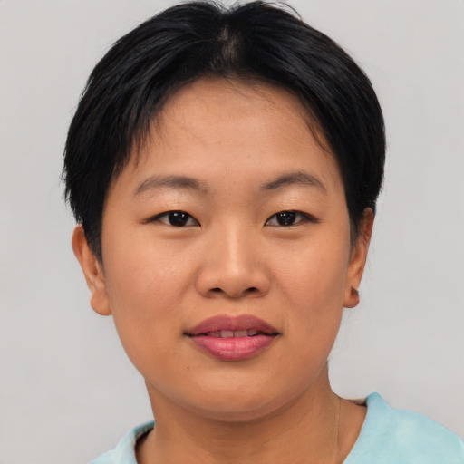 Joyful asian young-adult female with short  brown hair and brown eyes