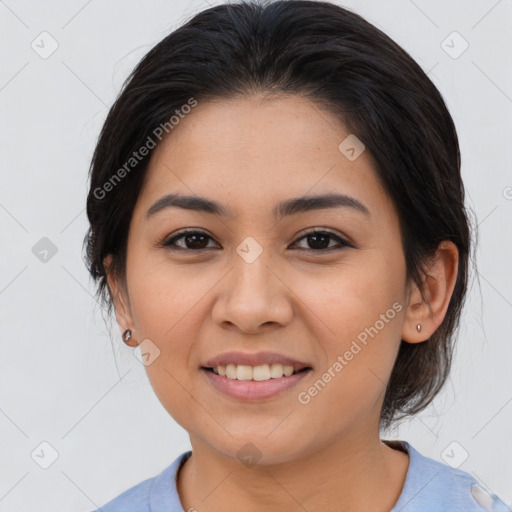 Joyful latino young-adult female with medium  brown hair and brown eyes