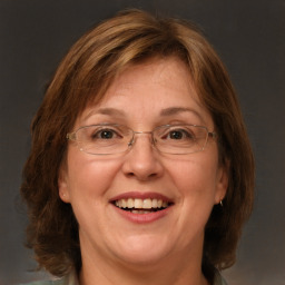 Joyful white adult female with medium  brown hair and green eyes