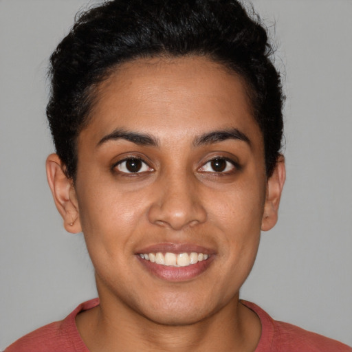 Joyful latino young-adult female with short  brown hair and brown eyes