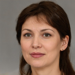 Joyful white adult female with medium  brown hair and brown eyes