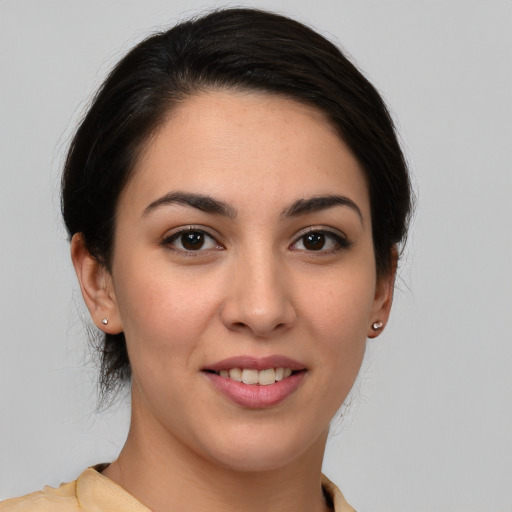 Joyful white young-adult female with medium  brown hair and brown eyes