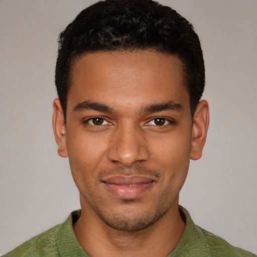 Joyful black young-adult male with short  brown hair and brown eyes