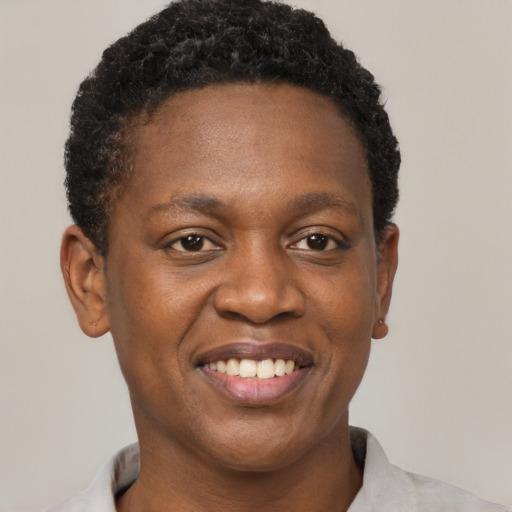 Joyful black young-adult male with short  brown hair and brown eyes