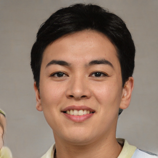 Joyful asian young-adult female with short  black hair and brown eyes