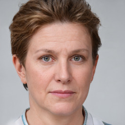 Joyful white adult female with short  brown hair and grey eyes