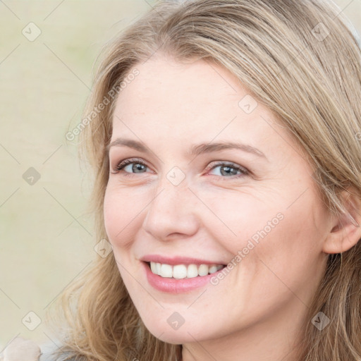 Joyful white young-adult female with long  brown hair and blue eyes