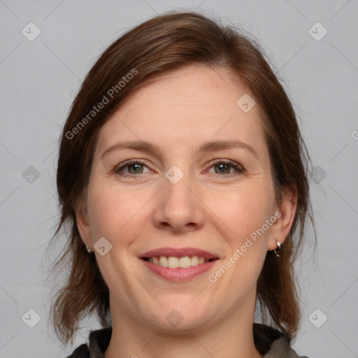 Joyful white adult female with medium  brown hair and grey eyes