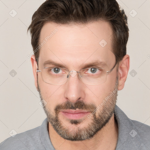 Joyful white adult male with short  brown hair and brown eyes