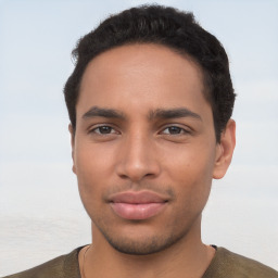 Joyful latino young-adult male with short  brown hair and brown eyes