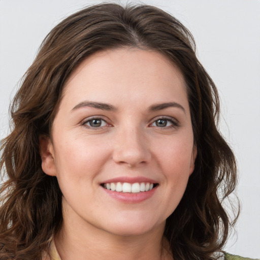 Joyful white young-adult female with medium  brown hair and green eyes