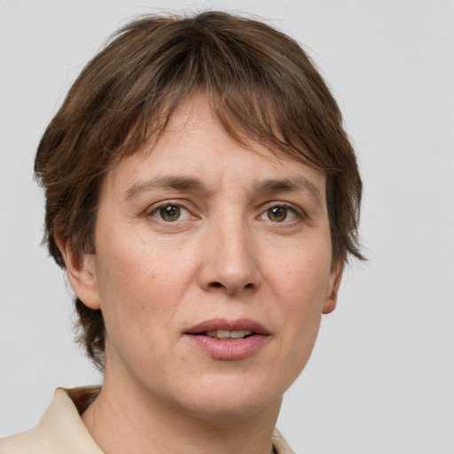 Joyful white adult female with short  brown hair and grey eyes