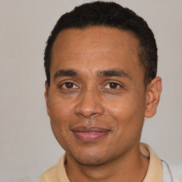 Joyful latino adult male with short  black hair and brown eyes