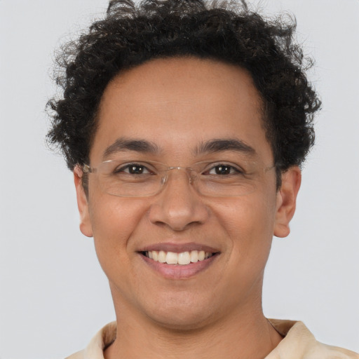 Joyful latino young-adult male with short  brown hair and brown eyes