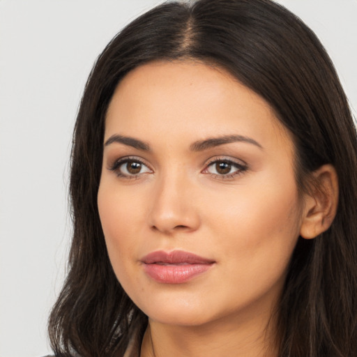 Joyful latino young-adult female with long  brown hair and brown eyes