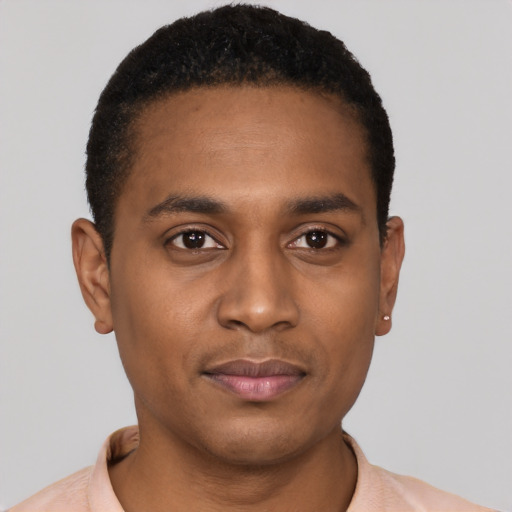 Joyful black young-adult male with short  black hair and brown eyes
