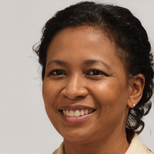 Joyful black adult female with medium  brown hair and brown eyes
