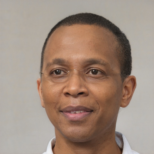 Joyful black adult male with short  brown hair and brown eyes