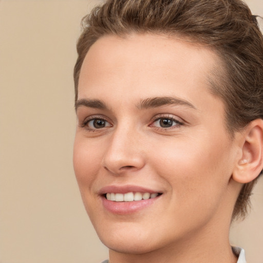 Joyful white young-adult female with short  brown hair and brown eyes