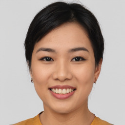 Joyful asian young-adult female with medium  black hair and brown eyes