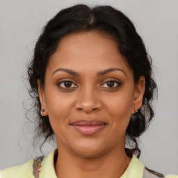 Joyful black young-adult female with medium  brown hair and brown eyes