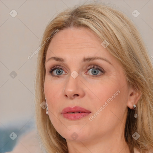 Joyful white adult female with medium  brown hair and blue eyes