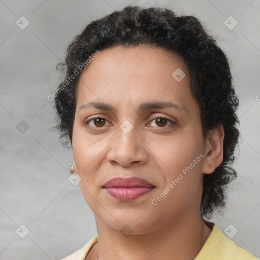 Joyful latino adult female with short  brown hair and brown eyes