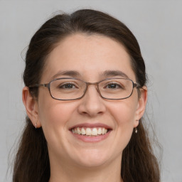 Joyful white adult female with medium  brown hair and grey eyes