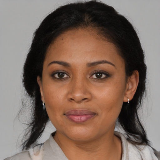 Joyful black adult female with medium  black hair and brown eyes