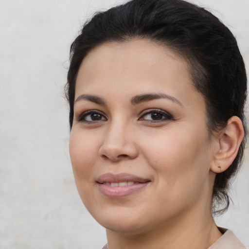 Joyful latino young-adult female with medium  brown hair and brown eyes