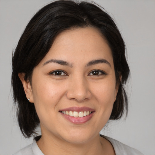 Joyful asian young-adult female with medium  brown hair and brown eyes