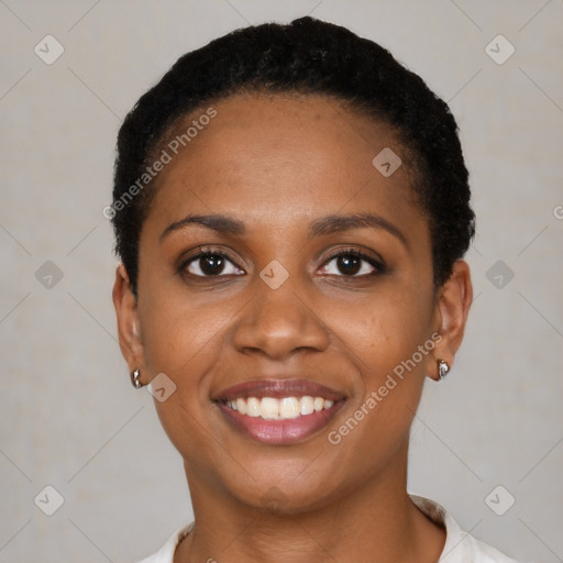 Joyful black young-adult female with short  black hair and brown eyes