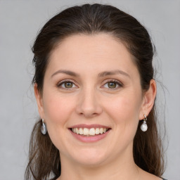 Joyful white young-adult female with medium  brown hair and green eyes