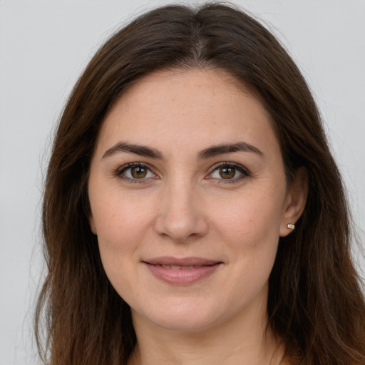 Joyful white young-adult female with long  brown hair and brown eyes