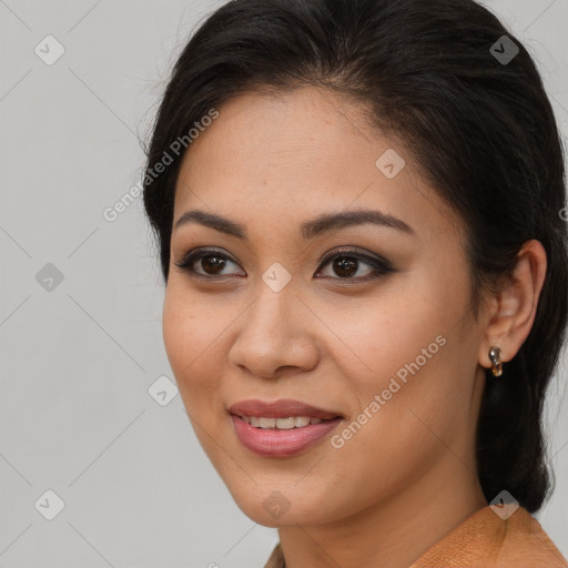 Joyful latino young-adult female with long  brown hair and brown eyes