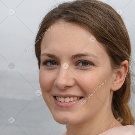 Joyful white young-adult female with medium  brown hair and grey eyes