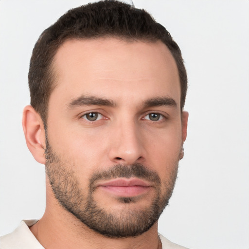 Joyful white young-adult male with short  brown hair and brown eyes