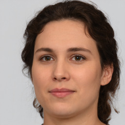 Joyful white young-adult female with medium  brown hair and green eyes