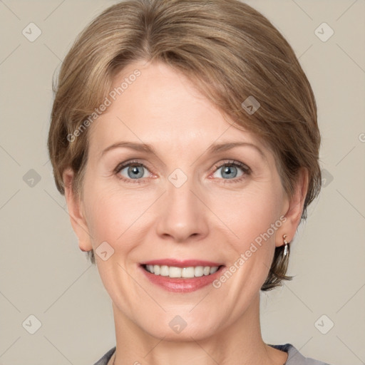 Joyful white adult female with medium  brown hair and grey eyes