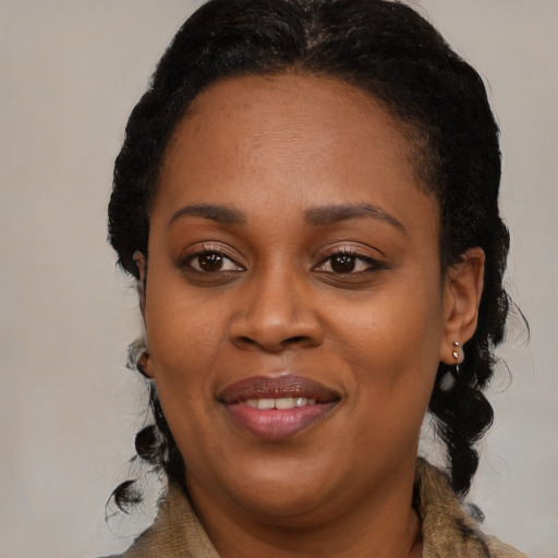 Joyful black adult female with medium  black hair and brown eyes