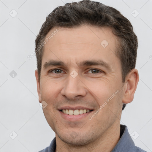 Joyful white adult male with short  brown hair and brown eyes