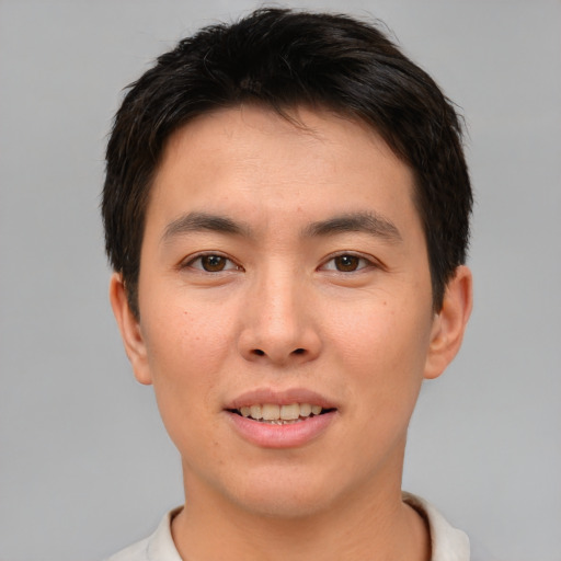Joyful asian young-adult male with short  brown hair and brown eyes